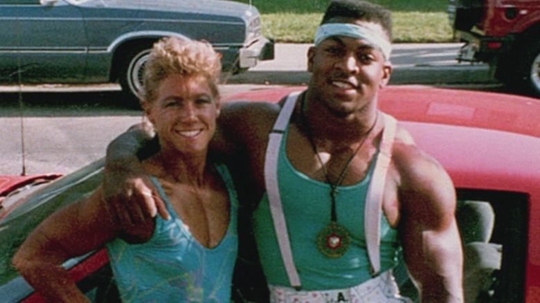 Sally and Ray McNeil standing by a car