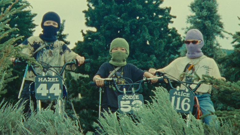 Kids in masks on bikes