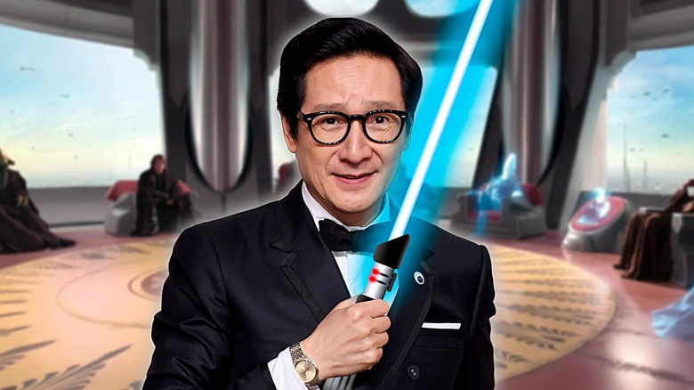 Ke Huy Quan holding lightsaber