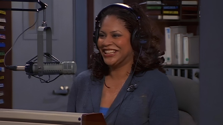 Mary sitting behind radio microphone